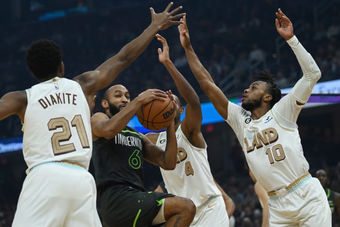 Nov 13, 2022; Cleveland, Ohio, USA; Minnesota Timberwolves guard Jordan McLaughlin (6) drives to the basket against Cleveland Cavaliers forward Mamadi Diakite (21) and forward Evan Mobley (4) and guard Darius Garland (10) during the first half at Rocket Mortgage FieldHouse. Mandatory Credit: Ken Blaze-USA TODAY Sports